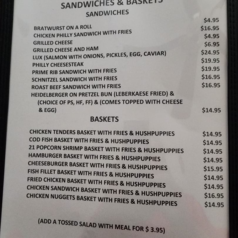 A close-up view of The Hub German Restaurant & Lounge's menu, featuring sandwiches and baskets.